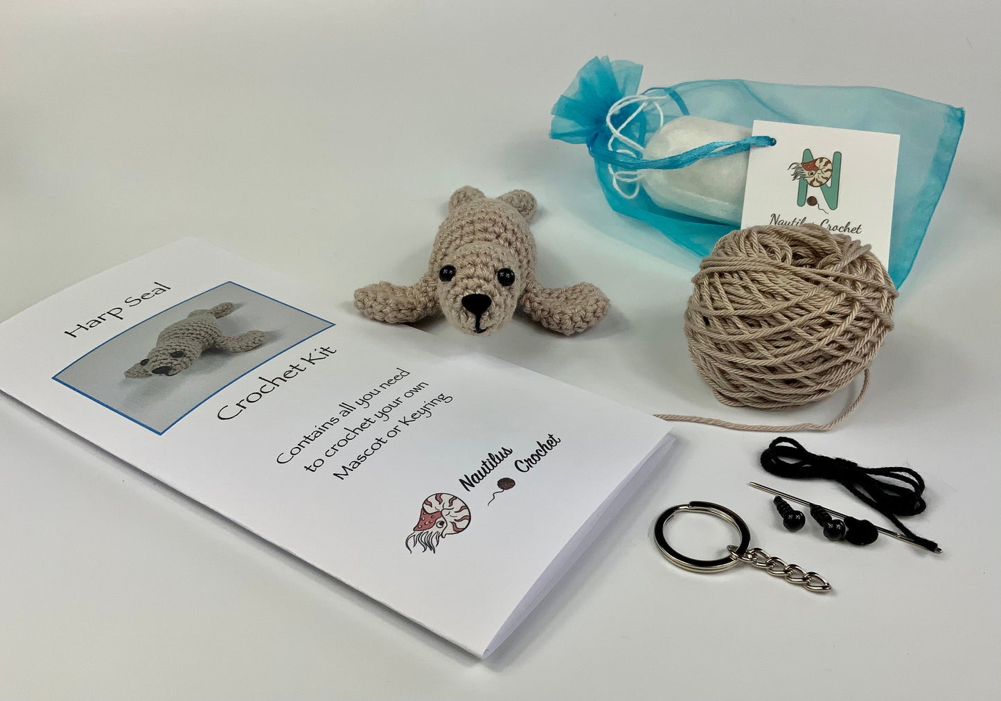 Harp Seal Kit. A full kit with luxury yarns and fittings plus a silver fish stitch-marker.