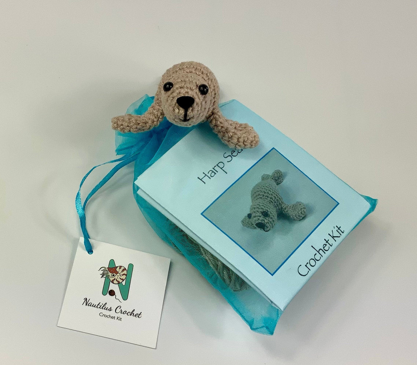 Harp Seal Kit. A full kit with luxury yarns and fittings plus a silver fish stitch-marker.