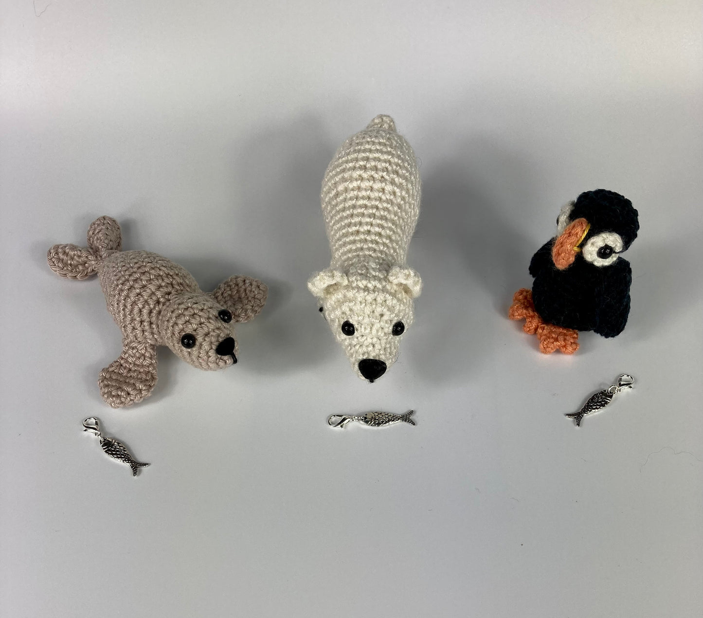 Harp Seal Kit. A full kit with luxury yarns and fittings plus a silver fish stitch-marker.